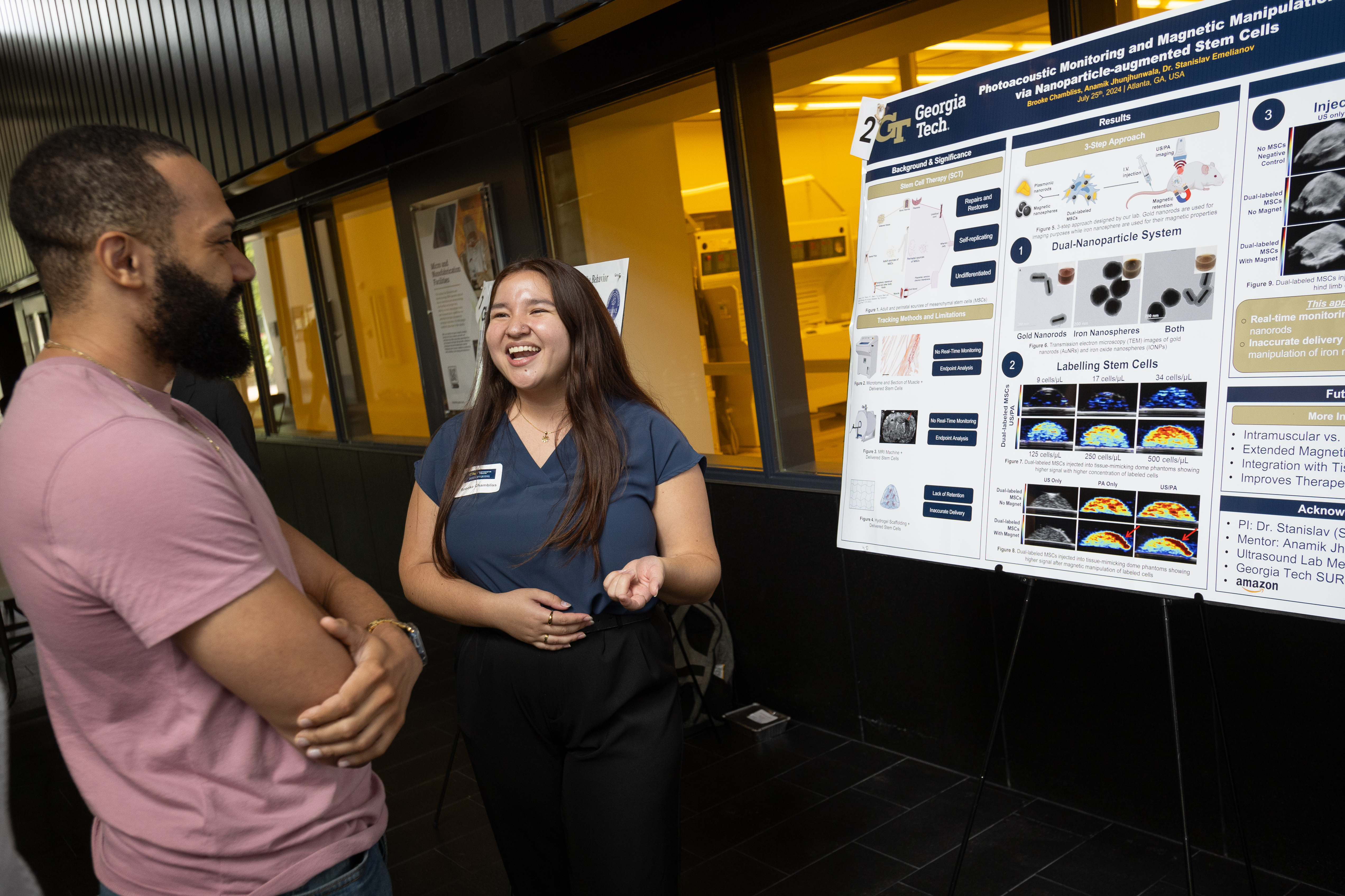 Brooke talks to someone at a poster presentation