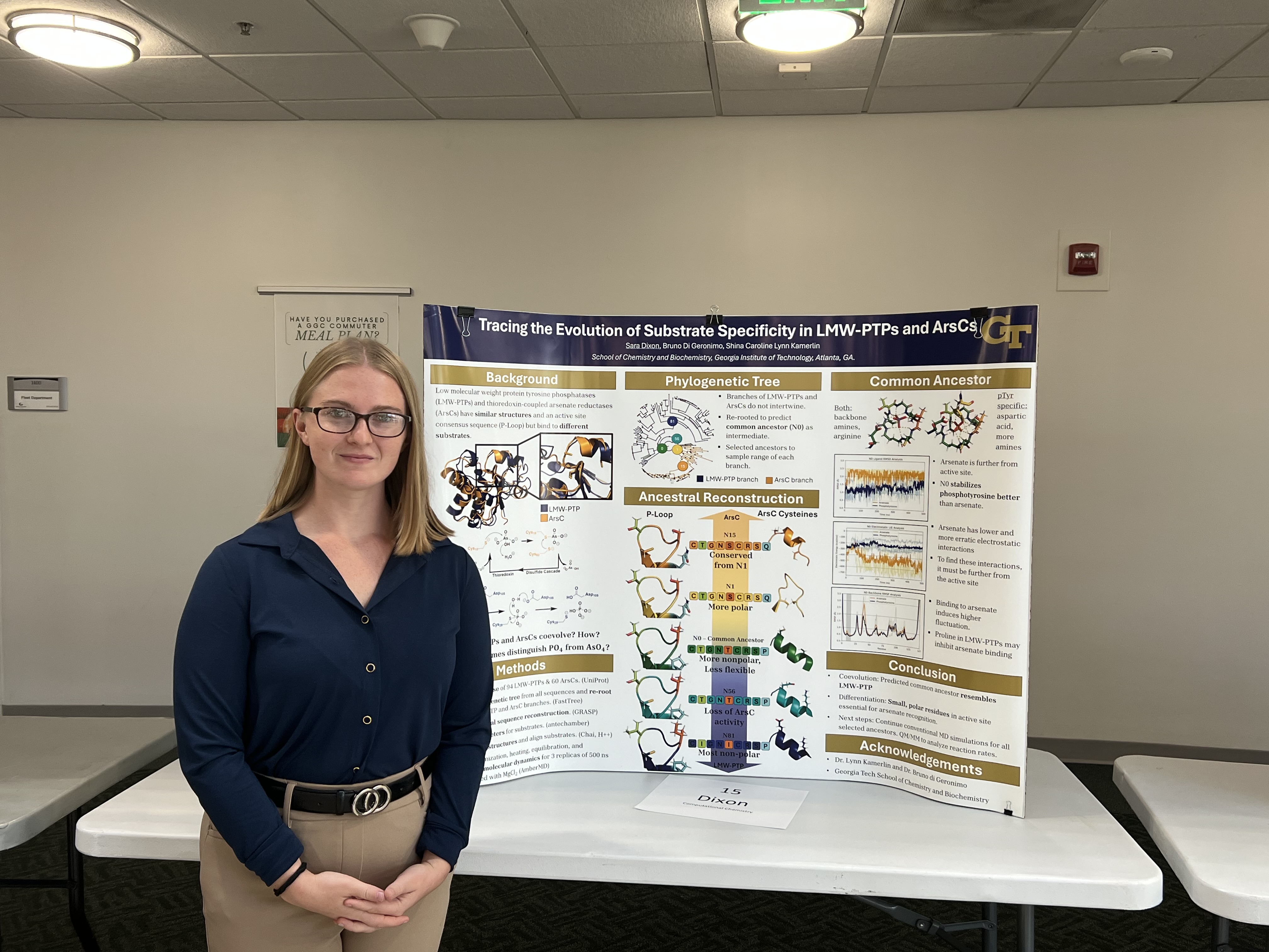 Sara stands by a poster about her research.
