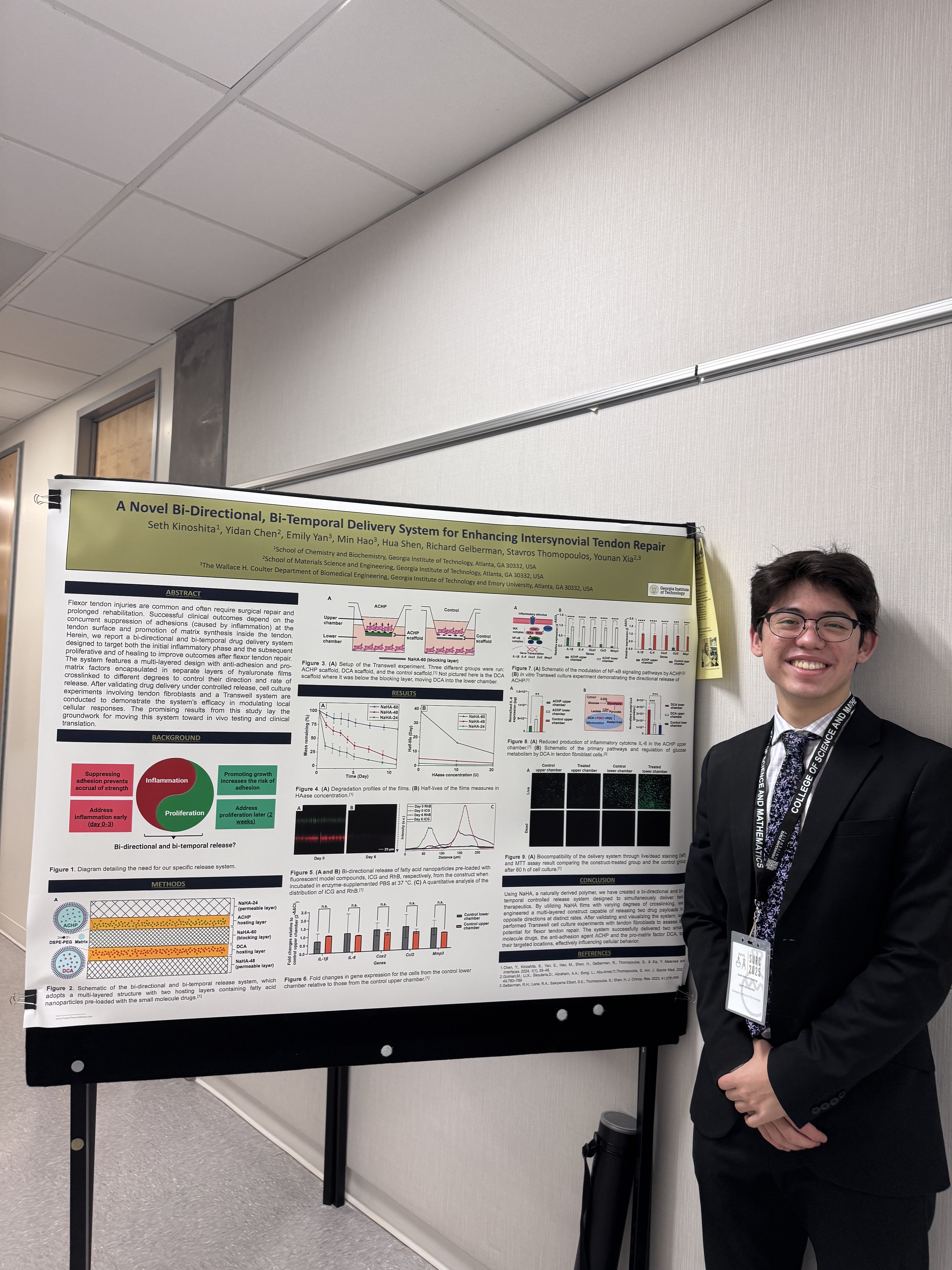 Seth stands in front of a poster about his research.