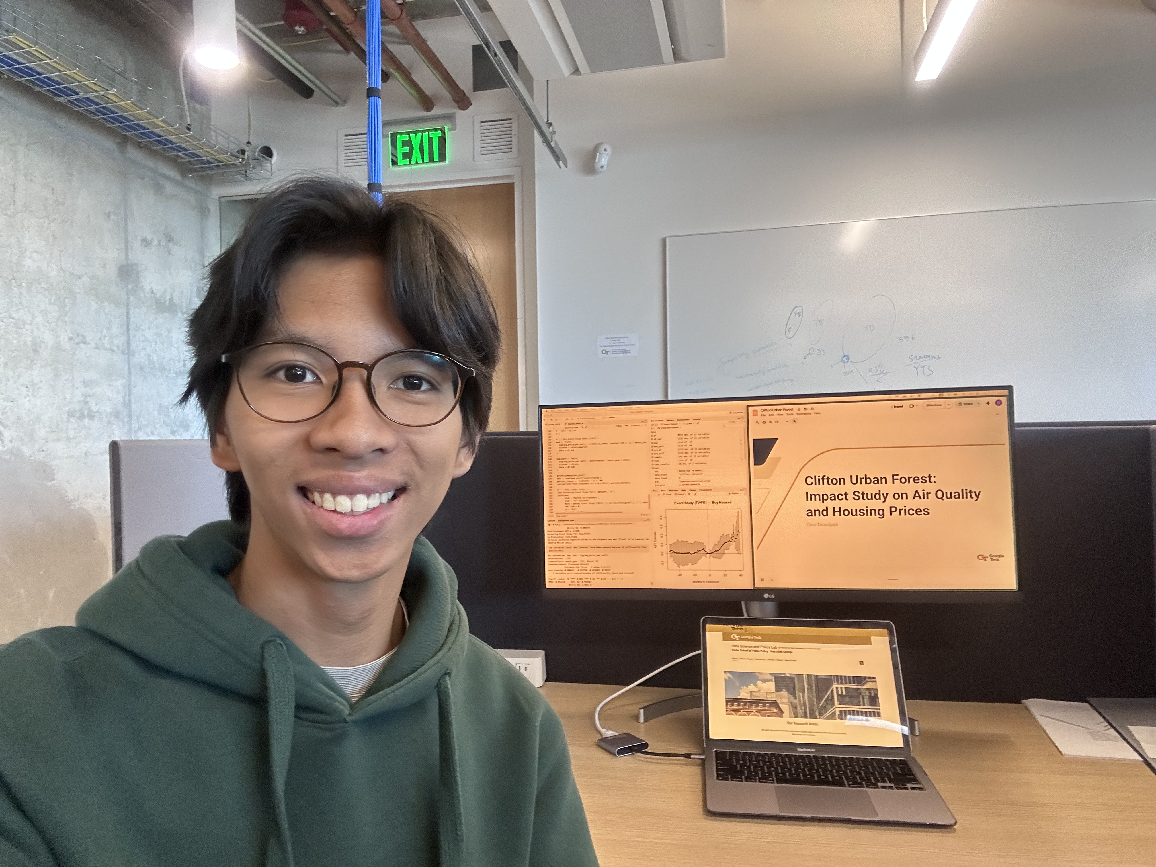 Divo faces the camera, with his laptop behind him, slightly to his left.